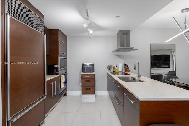 465 Brickell Ave Unit 417, Miami, FL 33131 - kitchen with built in appliances, wall chimney range hood, modern cabinets, light countertops, and a peninsula