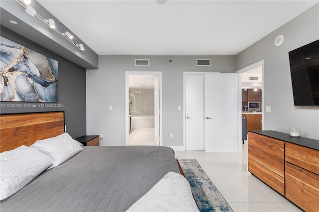 465 Brickell Ave Unit 417, Miami, FL 33131 - bedroom featuring light tile patterned floors and ensuite bath