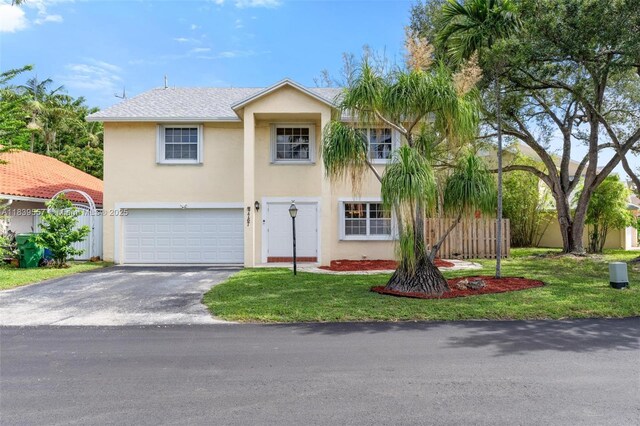 7767 NW 187th Ter, Miami, FL 33015 - view of front of house featuring stucco siding, a garage, and driveway