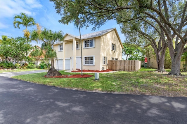 7767 NW 187th Ter, Miami, FL 33015 - view of front of property featuring an attached garage, stucco siding, and driveway