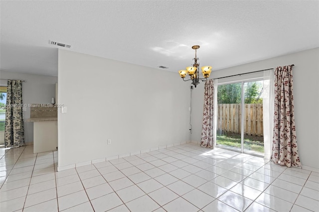 7767 NW 187th Ter, Miami, FL 33015 - unfurnished room with light tile patterned floors, a chandelier, and a textured ceiling