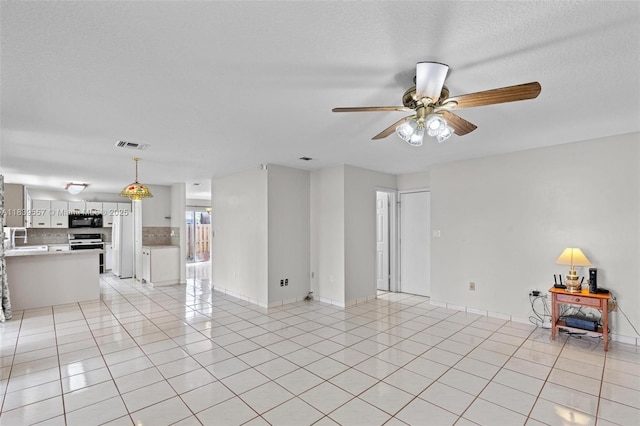 7767 NW 187th Ter, Miami, FL 33015 - unfurnished living room featuring ceiling fan and light tile patterned floors