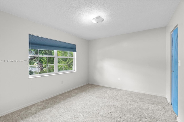 7767 NW 187th Ter, Miami, FL 33015 - empty room with carpet flooring and a textured ceiling