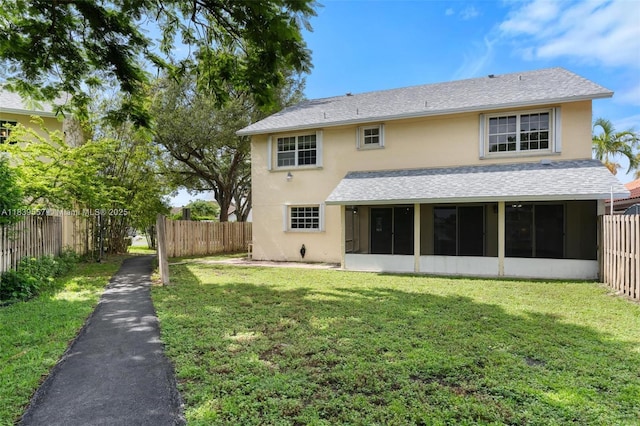 7767 NW 187th Ter, Miami, FL 33015 - back of house featuring stucco siding, a sunroom, a fenced backyard, and roof with shingles