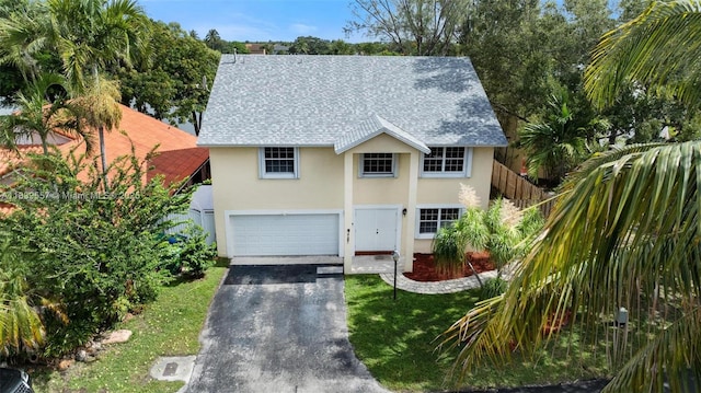 7767 NW 187th Ter, Miami, FL 33015 - traditional-style house featuring stucco siding, asphalt driveway, a garage, roof with shingles, and a front yard