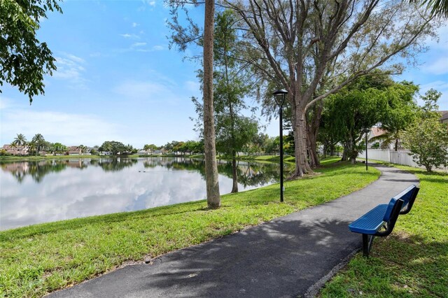 7767 NW 187th Ter, Miami, FL 33015 - view of home's community featuring a water view and a lawn