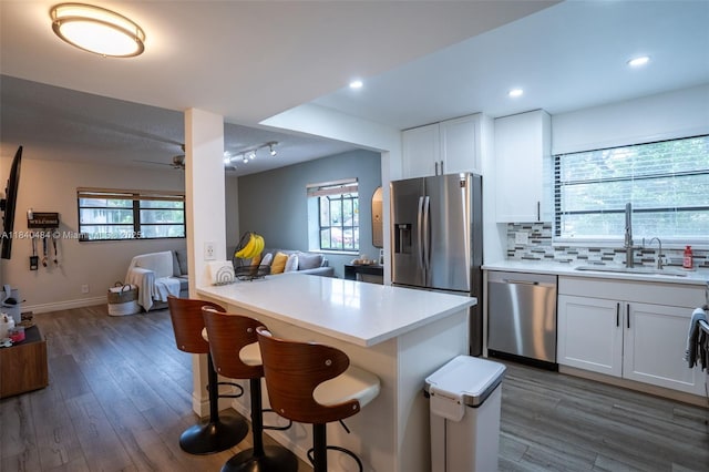 7625 NW 79th Ave Unit 101, Tamarac, FL 33321 - kitchen with stainless steel appliances, open floor plan, a breakfast bar, dark wood-style floors, and recessed lighting