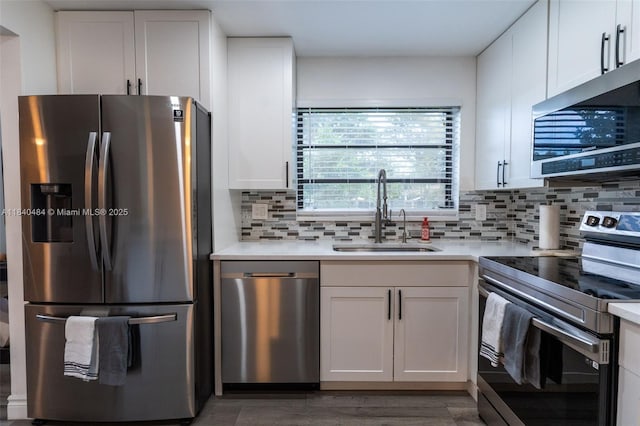7625 NW 79th Ave Unit 101, Tamarac, FL 33321 - kitchen featuring appliances with stainless steel finishes, white cabinetry, decorative backsplash, and light countertops
