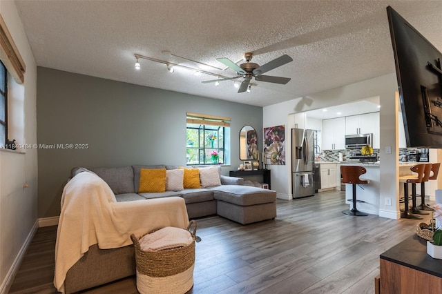 7625 NW 79th Ave Unit 101, Tamarac, FL 33321 - living room featuring a ceiling fan, wood finished floors, and a textured ceiling