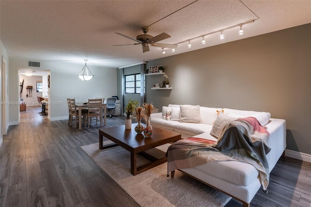 7625 NW 79th Ave Unit 101, Tamarac, FL 33321 - living area with a textured ceiling, ceiling fan, and dark wood-style floors