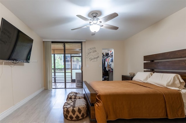 7625 NW 79th Ave Unit 101, Tamarac, FL 33321 - bedroom with wood finished floors, access to exterior, ceiling fan, and a walk in closet