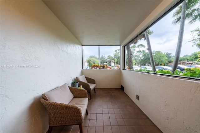 7625 NW 79th Ave Unit 101, Tamarac, FL 33321 - sunroom featuring a textured wall and tile patterned flooring