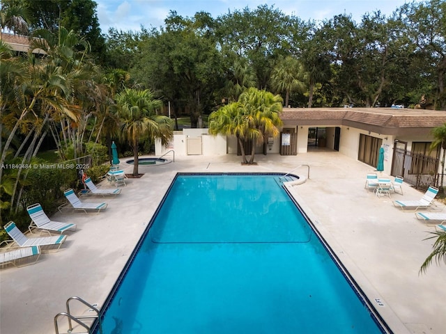 7625 NW 79th Ave Unit 101, Tamarac, FL 33321 - community pool featuring a patio and view of scattered trees