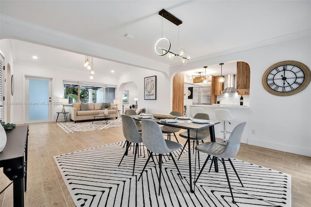 5701 SW 33rd St, Miami, FL 33155 - dining area with arched walkways, ornamental molding, light wood-style floors, and a chandelier