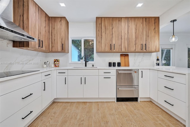 5701 SW 33rd St, Miami, FL 33155 - kitchen with wall chimney range hood, light countertops, and light wood-style flooring