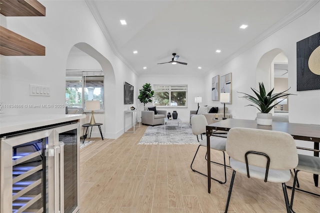 5701 SW 33rd St, Miami, FL 33155 - dining area with beverage cooler, ceiling fan, crown molding, arched walkways, and light wood finished floors