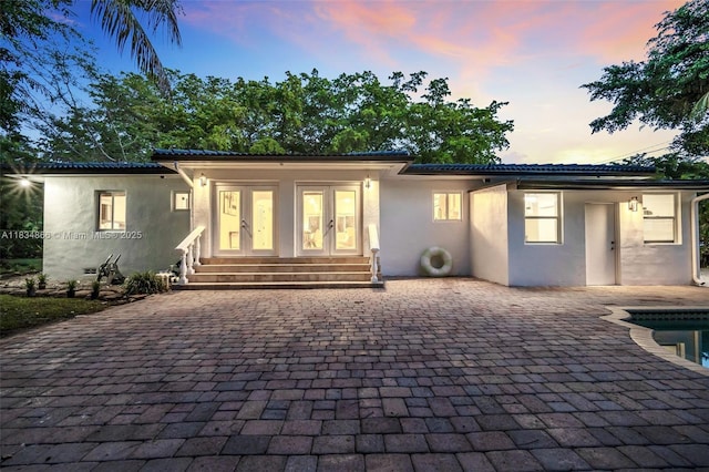 5701 SW 33rd St, Miami, FL 33155 - view of front facade with stucco siding, french doors, entry steps, a patio area, and an outdoor pool