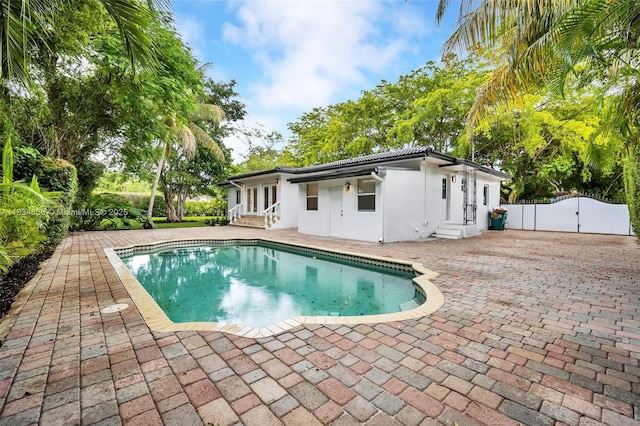 5701 SW 33rd St, Miami, FL 33155 - view of swimming pool with a gate, entry steps, french doors, and a patio