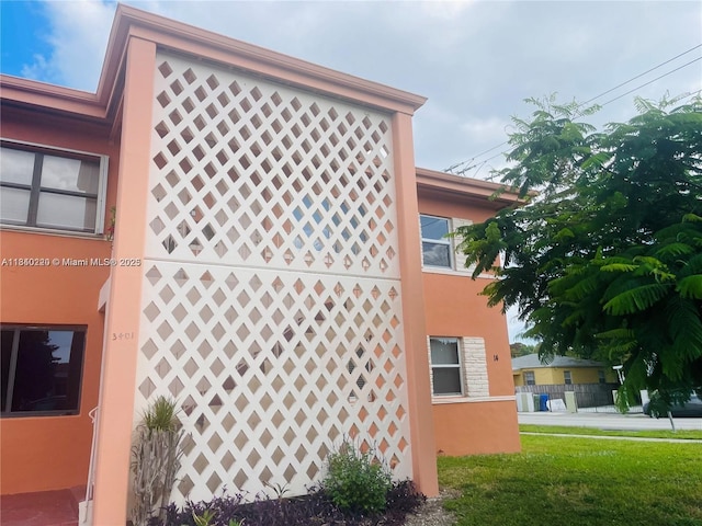 3401 SW 11th St Unit 1B, Miami, FL 33135 - view of side of home with stucco siding and a yard
