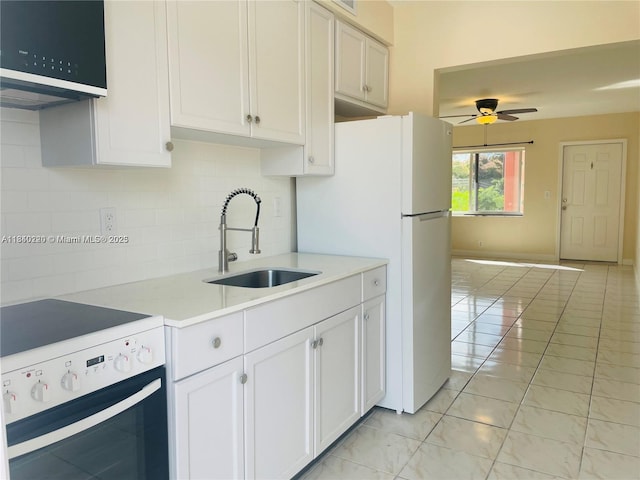 3401 SW 11th St Unit 1B, Miami, FL 33135 - kitchen featuring range, freestanding refrigerator, backsplash, a ceiling fan, and light countertops