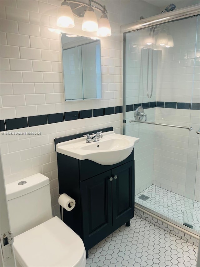 3401 SW 11th St Unit 1B, Miami, FL 33135 - bathroom featuring tile walls, vanity, a stall shower, and tile patterned floors