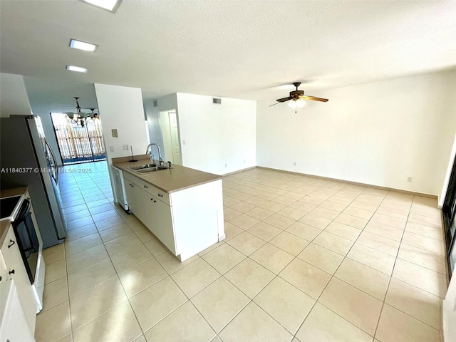 1725 SW 131st Place Cir S, Miami, FL 33175 - kitchen featuring ceiling fan, a chandelier, light tile patterned floors, stove, and white cabinetry