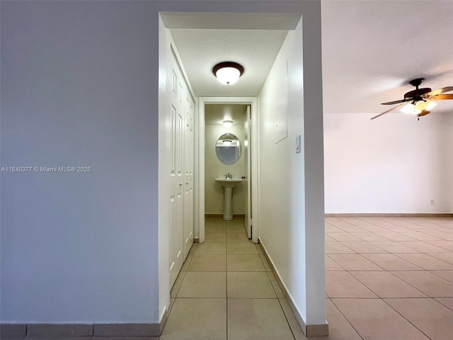 1725 SW 131st Place Cir S, Miami, FL 33175 - hallway with light tile patterned flooring and a textured ceiling