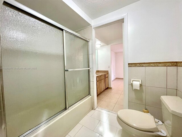 1725 SW 131st Place Cir S, Miami, FL 33175 - full bath featuring shower / bath combination with glass door, tile patterned floors, a wainscoted wall, and vanity