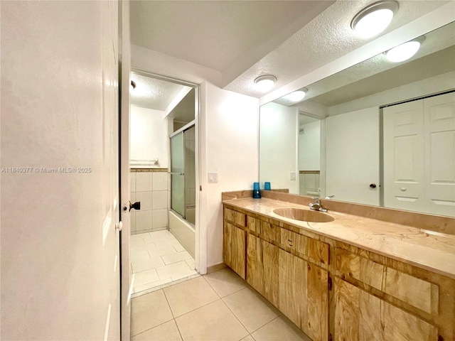 1725 SW 131st Place Cir S, Miami, FL 33175 - full bathroom with tile patterned flooring, vanity, combined bath / shower with glass door, and a textured ceiling