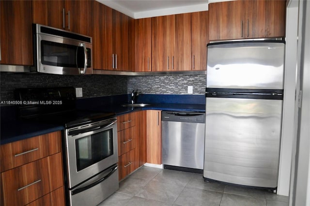 13499 Biscayne Blvd Unit 1011, North Miami, FL 33181 - kitchen with stainless steel appliances, dark countertops, light tile patterned flooring, backsplash, and modern cabinets