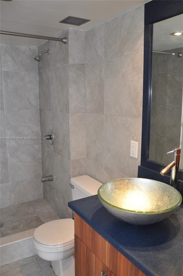 13499 Biscayne Blvd Unit 1011, North Miami, FL 33181 - full bath with vanity, a tile shower, tile walls, and tile patterned flooring