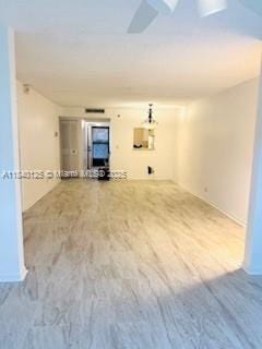 4760 W Lucerne Lakes Blvd W Unit 108, Lake Worth, FL 33467 - unfurnished living room featuring wood finished floors and baseboards