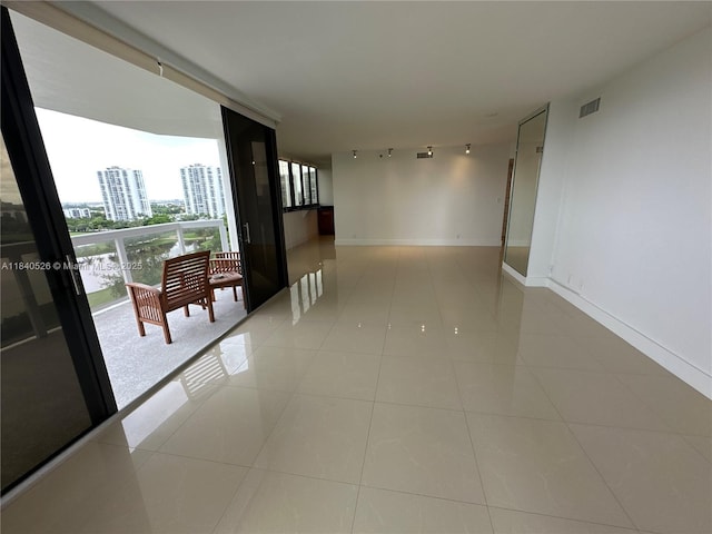 20185 E Country Club Dr Unit 1105, Aventura, FL 33180 - unfurnished room featuring track lighting, a wall of windows, light tile patterned flooring, and a city view