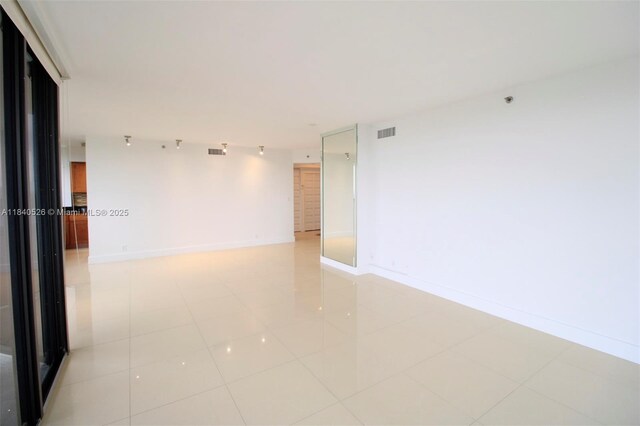20185 E Country Club Dr Unit 1105, Aventura, FL 33180 - spare room featuring light tile patterned flooring and baseboards