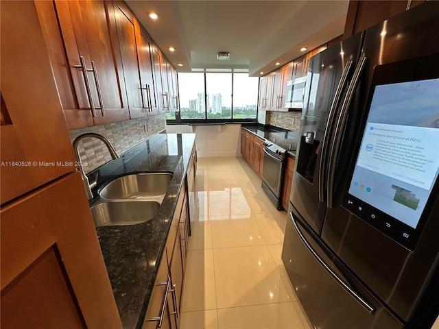 20185 E Country Club Dr Unit 1105, Aventura, FL 33180 - kitchen with stainless steel appliances, tasteful backsplash, light tile patterned floors, recessed lighting, and dark stone countertops