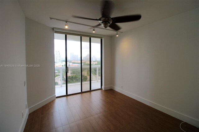 20185 E Country Club Dr Unit 1105, Aventura, FL 33180 - empty room with rail lighting, a ceiling fan, floor to ceiling windows, and dark wood-style floors