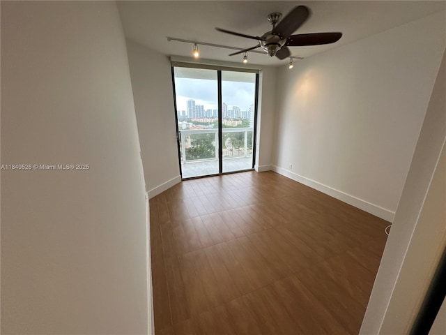 20185 E Country Club Dr Unit 1105, Aventura, FL 33180 - unfurnished room with a ceiling fan, rail lighting, dark wood-style floors, and a city view