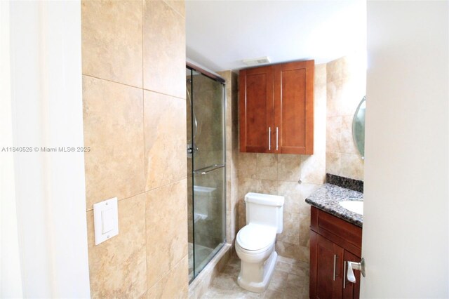 20185 E Country Club Dr Unit 1105, Aventura, FL 33180 - bathroom featuring tile walls, vanity, and a stall shower
