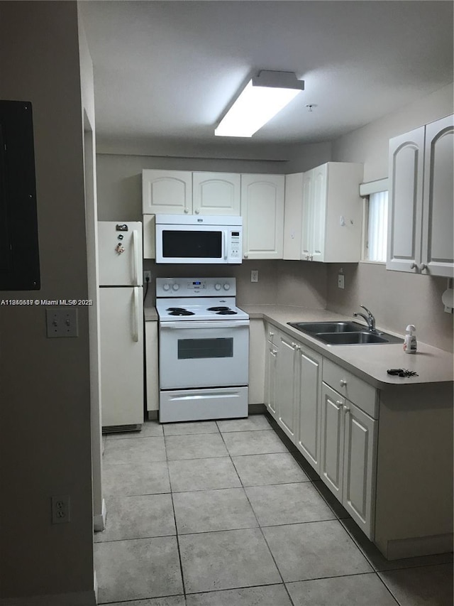 3201 W Flagler St Unit 102, Miami, FL 33135 - kitchen with white appliances, white cabinetry, light countertops, and light tile patterned floors