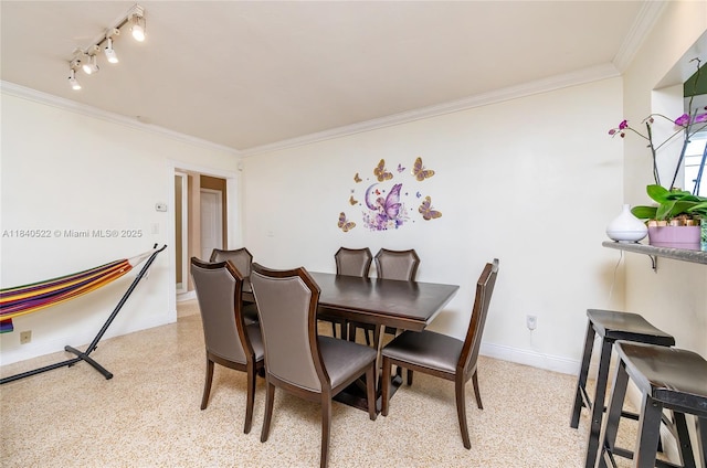 9370 SW 61st St, Miami, FL 33173 - dining space featuring ornamental molding, rail lighting, and dark speckled floor