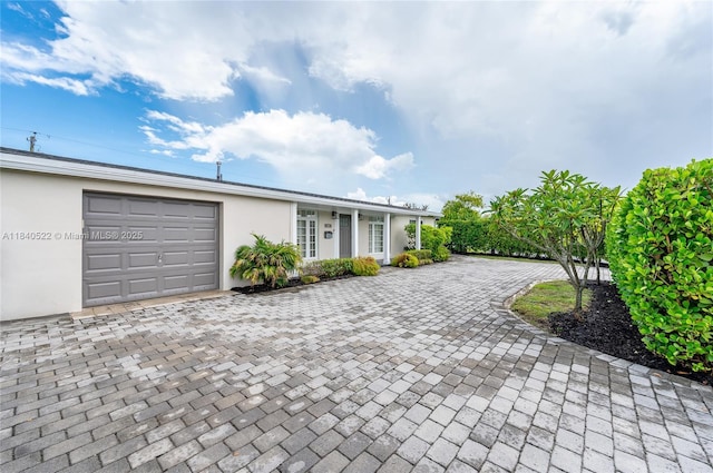 9370 SW 61st St, Miami, FL 33173 - single story home featuring an attached garage, decorative driveway, and stucco siding