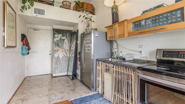 1521 Lenox Ave Unit 307, Miami Beach, FL 33139 - kitchen with stainless steel appliances, a high ceiling, and glass insert cabinets