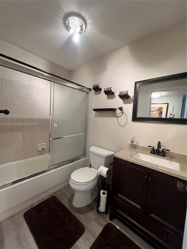 10415 E Clairmont Cir Unit 212, Tamarac, FL 33321 - bathroom with vanity, wood finished floors, and shower / bath combination with glass door