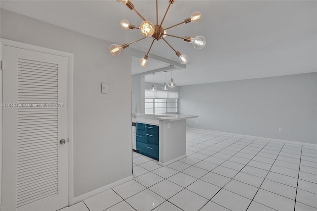 1100 11th St Unit 204, Miami Beach, FL 33139 - kitchen featuring a chandelier, blue cabinets, light tile patterned floors, light countertops, and open floor plan