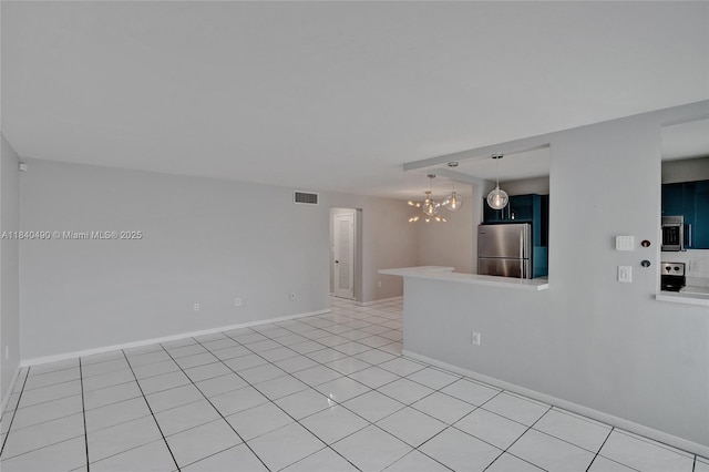 1100 11th St Unit 204, Miami Beach, FL 33139 - spare room featuring a chandelier and light tile patterned floors