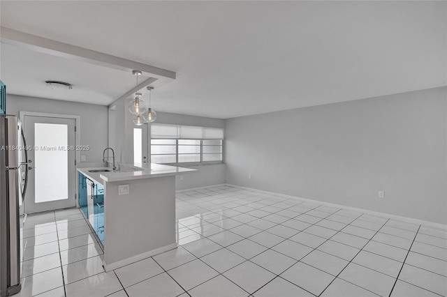 1100 11th St Unit 204, Miami Beach, FL 33139 - kitchen featuring freestanding refrigerator, light countertops, light tile patterned floors, and open floor plan