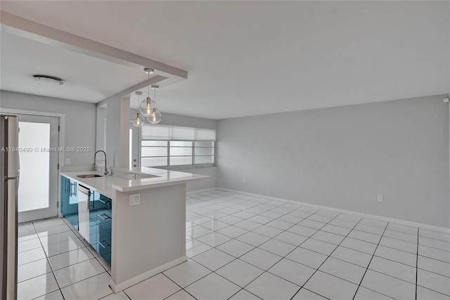 1100 11th St Unit 204, Miami Beach, FL 33139 - kitchen with light tile patterned floors, light countertops, open floor plan, and pendant lighting