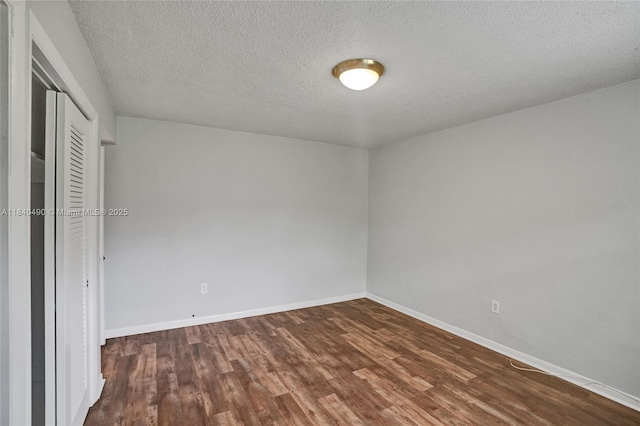 1100 11th St Unit 204, Miami Beach, FL 33139 - unfurnished bedroom featuring dark wood-type flooring, a closet, and a textured ceiling