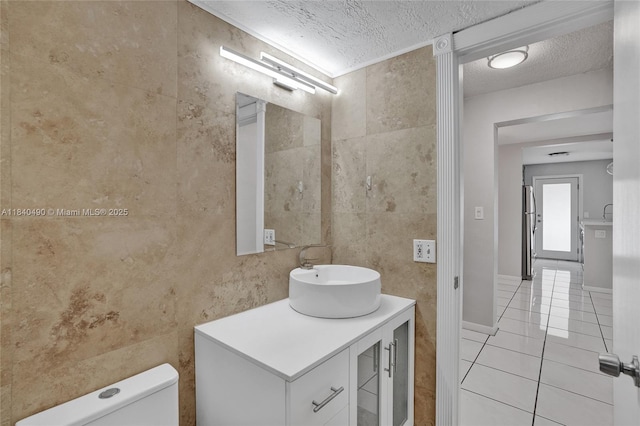 1100 11th St Unit 204, Miami Beach, FL 33139 - bathroom with a textured ceiling, tile walls, tile patterned flooring, and vanity