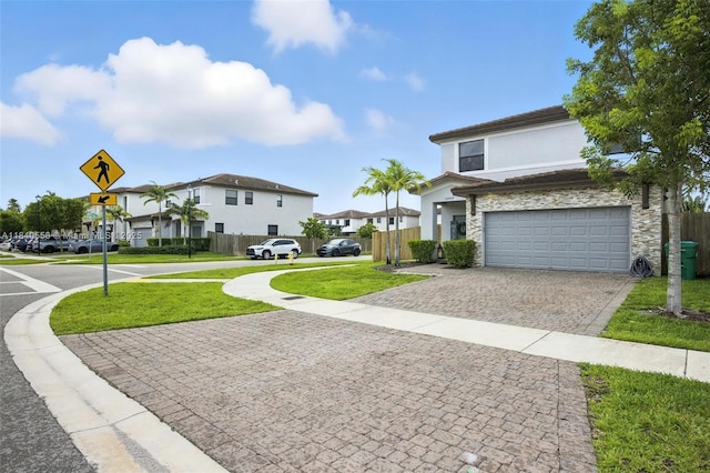 25009 SW 108th Ave, Homestead, FL 33032 - view of front of house featuring decorative driveway, stucco siding, an attached garage, stone siding, and a residential view